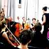 Metropolitan Chamber Orchestra sharing some laughs in rehearsal